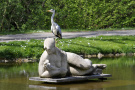 Graureiher auf einer Skulptur in einem Park sitzend